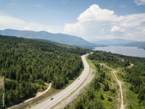 Aerial view of Trans-Canada Highway during a vibrant sunny summer day. Taken near Shuswap Lake, Blind Bay, BC, Canada.