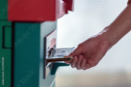 Closeup woman holding the wallet and withdrawing the cash via ATM  business Automatic Teller Machine concept