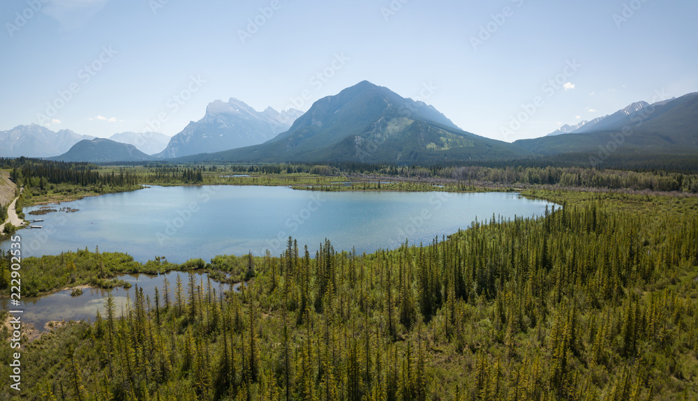 Aerial panoramic view of Vermilion Lakes during a vibrant summer day. Taken in Banff, Alberta, Canada.