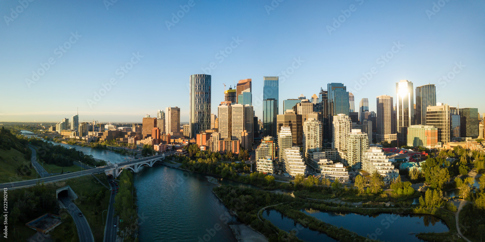 Fototapeta premium Aerial panoramic view of a beautiful modern cityscape during a vibrant sunny sunrise. Taken in Calgary Downtown, Alberta, Canada.