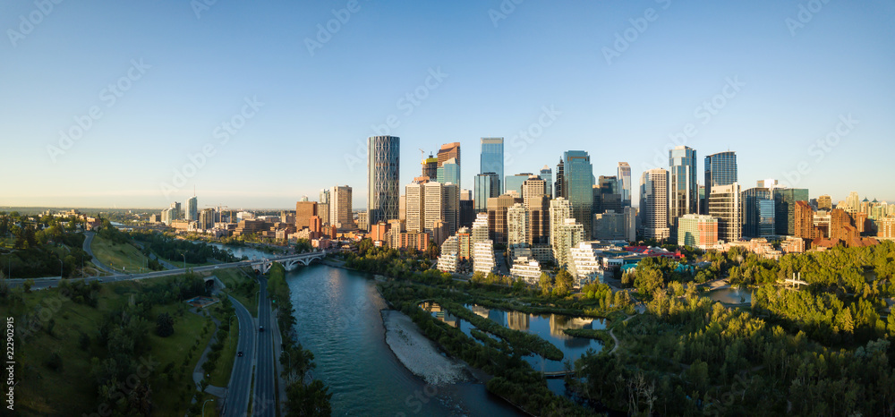 Aerial panoramic view of a beautiful modern cityscape during a vibrant sunny sunrise. Taken in Calgary Downtown, Alberta, Canada.