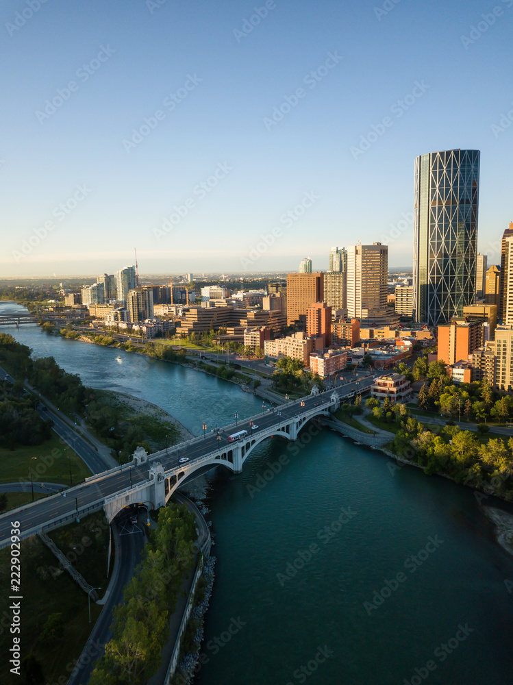 Aerial view of a beautiful modern cityscape during a vibrant sunny sunrise. Taken in Calgary Downtown, Alberta, Canada. Aerial view of a beautiful modern cityscape during a vibrant sunny sunrise. Taken in Calgary Downtown, Alberta, Canada.