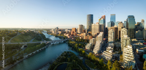 Aerial panoramic view of a beautiful modern cityscape during a vibrant sunny sunrise. Taken in Calgary Downtown, Alberta, Canada. photo