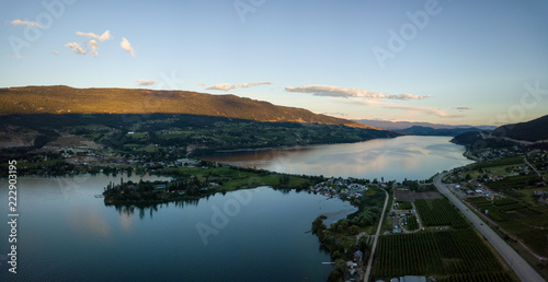 Aerial panoramic view of a small town, Oyama, during a vibrant summer sunset. Located near Kelowna and Vernon, BC, Canada. photo