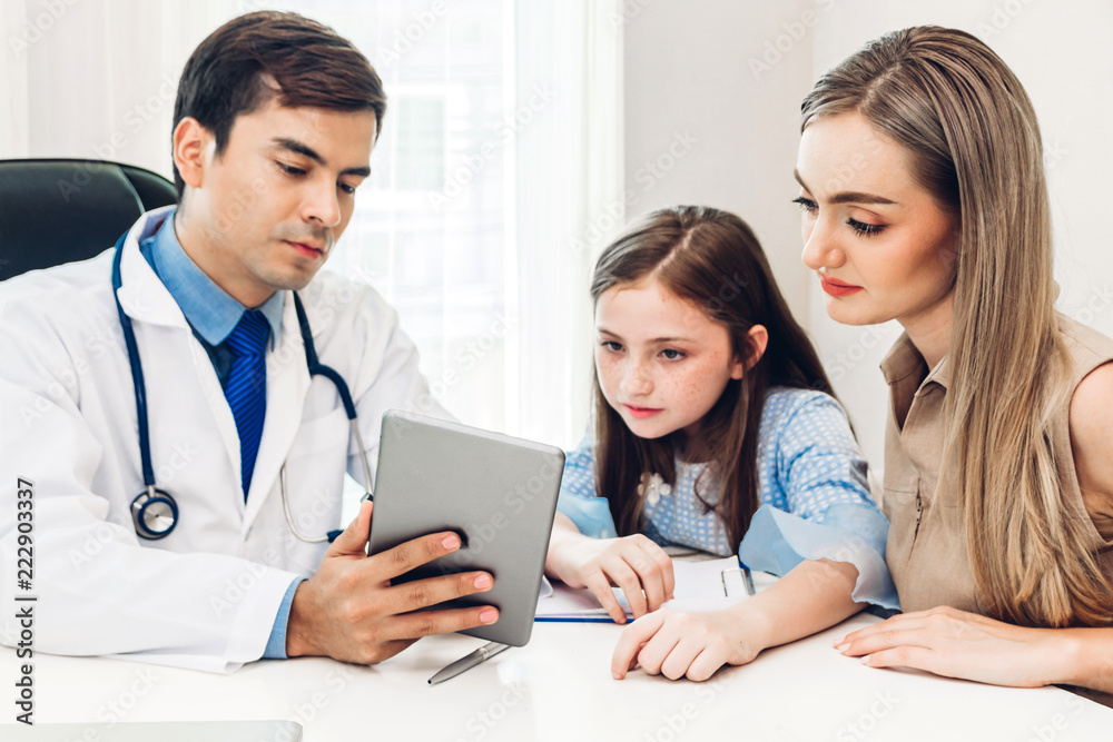 Doctor discussing and consulting and check up information with little girl and mom in hospital.A little girl has sick.healthcare and medicine Doctor discussing and consulting and check up information with little girl and mom in hospital.A little girl has sick.healthcare and medicine