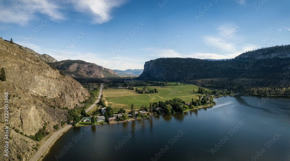Fototapeta premium Aerial panoramic view of Okanagan Hwy near Vaseux Lake during a sunny summer day. Located between Oliver and Penticton, BC, Canada.