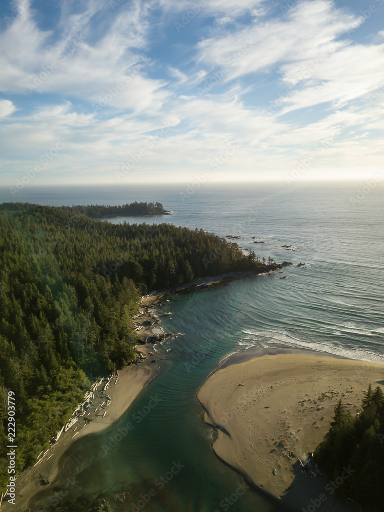 Aerial view of a beautiful beach on Pacific Ocean Coast druing a vibrant sunny summer sunset. Taken in Raft Cove Provincial Park, Nortern Vancouver Island, BC, Canada.