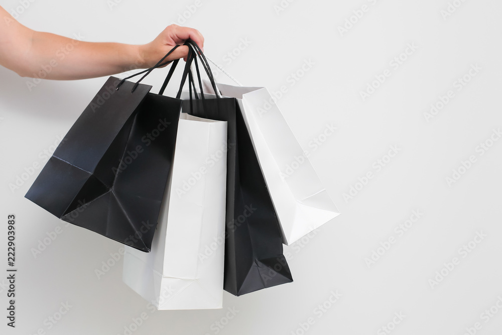 female hand with shopping bags on white background isolated