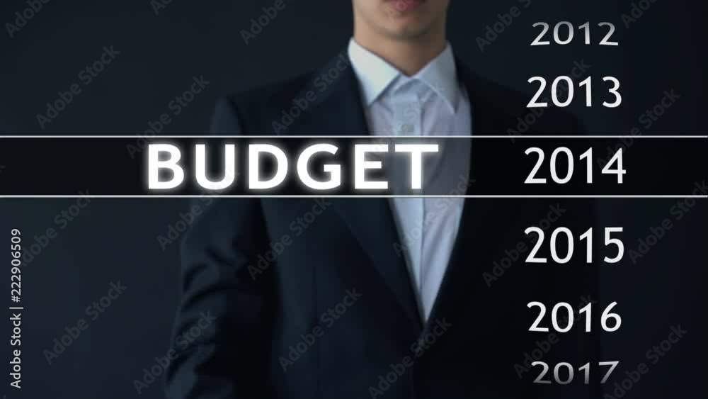 2014 budget, businessman selects file on virtual screen, annual financial report 2014 budget, businessman selects file on virtual screen, annual financial report