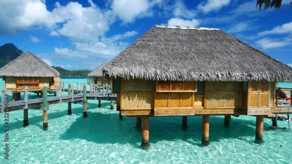 Luxury overwater villas on blue lagoon, white sandy beach and Otemanu mountain at Bora Bora island, Tahiti, French Polynesia Luxury overwater villas on blue lagoon, white sandy beach and Otemanu mountain at Bora Bora island, Tahiti, French Polynesia