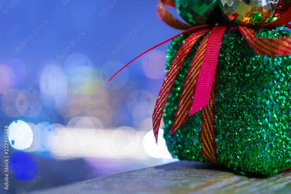 Christmas gift with beautiful bokeh city background for holiday celebration concept.