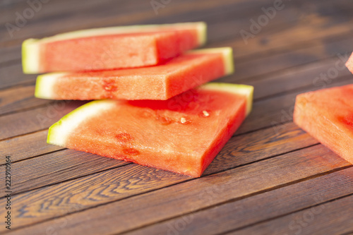 Red sliced watermelon on wooden table background