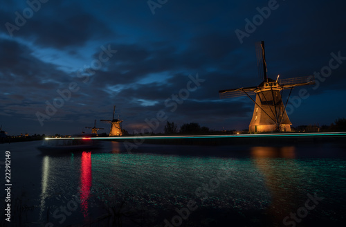 the windmills in Kinderdijk are illuminated photo