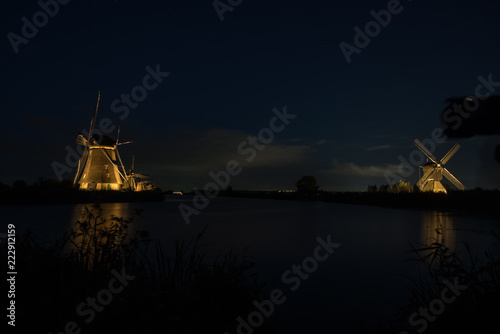 the windmills in Kinderdijk are illuminated © denboma