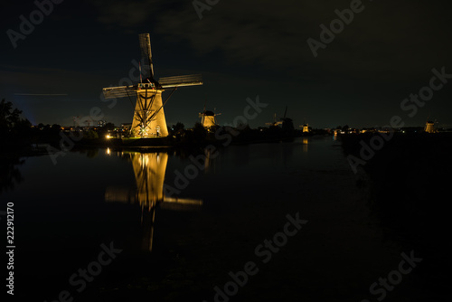 the windmills in Kinderdijk are illuminated © denboma