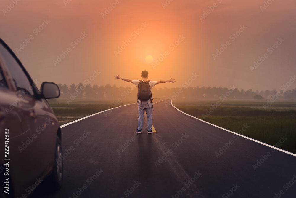 Freedom and Spiration of Life. A man standing on the road with Sunset scene.