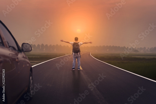 Freedom and Spiration of Life. A man standing on the road with Sunset scene.