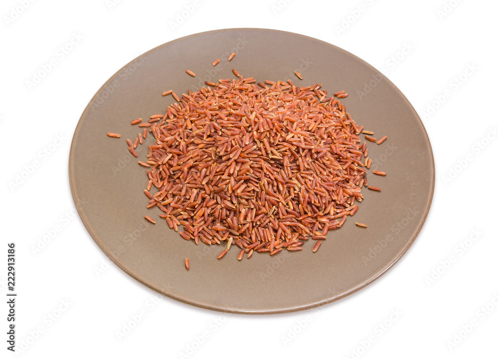 Fototapeta premium Uncooked red rice on the brown dish