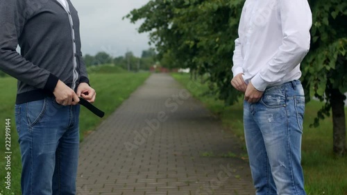 Two men unbutton their pants on the street, gays, homosexuality