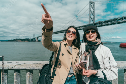 Photography sisters visiting a famous place happily