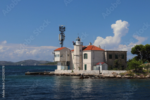 Wallpaper Mural Europe. Adriatic seaof Mediterranean area. Dalmatian region. Croatia.  Outpost of a maritime port with a beacon near Sibenik city. Duty station of the Marine Police in sunny day. Torontodigital.ca