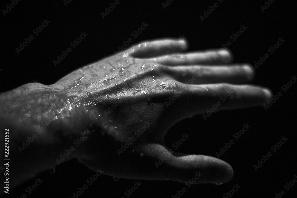 Wet hand,bleck and white color photo