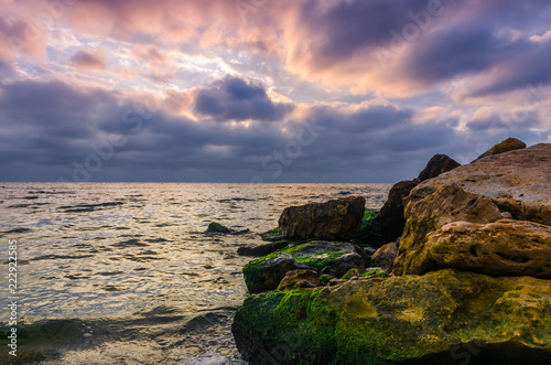 Sunset on the sea beach with stones