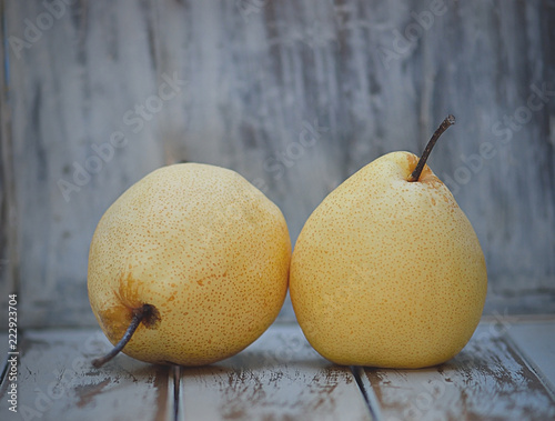Pear fruit isolated on wooden background.
