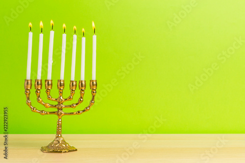 Bronze Hanukkah menorah with burning candles