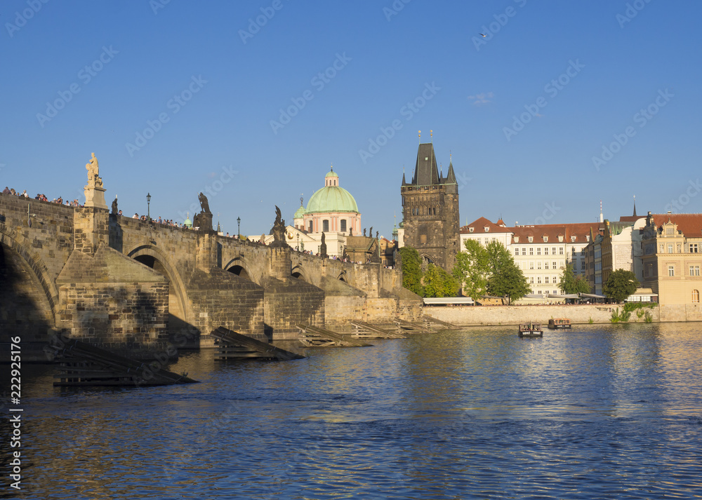 View of Charles Bridge in Prague, Czech Republic. Gothic Charles Bridge is one of the most visited sights in Prague. Architecture and landmark of Prague, golden light, sunny summer day