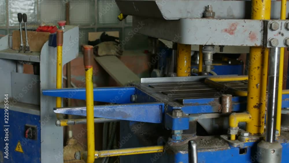 Press machine for manufacturing interlocking concrete pavers for road surface covering or outdoor floor. Produced by compacting sand-cement weight in the matrix upon reaching a certain density tiles Press machine for manufacturing interlocking concrete pavers for road surface covering or outdoor floor. Produced by compacting sand-cement weight in the matrix upon reaching a certain density tiles