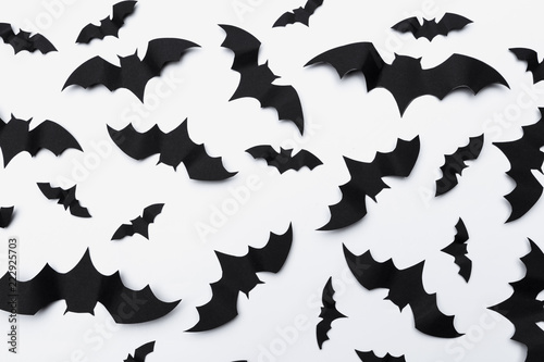 halloween and decoration concept - paper bats flying