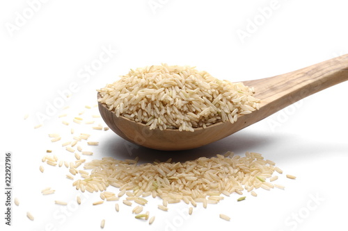 Integral rice pile with wooden spoon isolated on white background