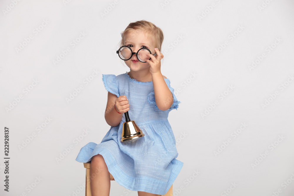 adorable little girls puts on glasses and rings a bell adorable little girls puts on glasses and rings a bell