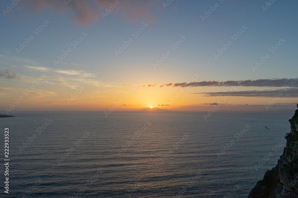 Golden sunset on Amalfi coast ovear sea with cloudy skies