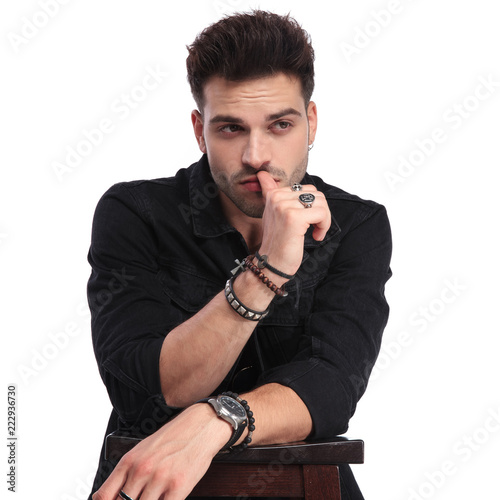 portrait of pensive man in black clothes looking to side