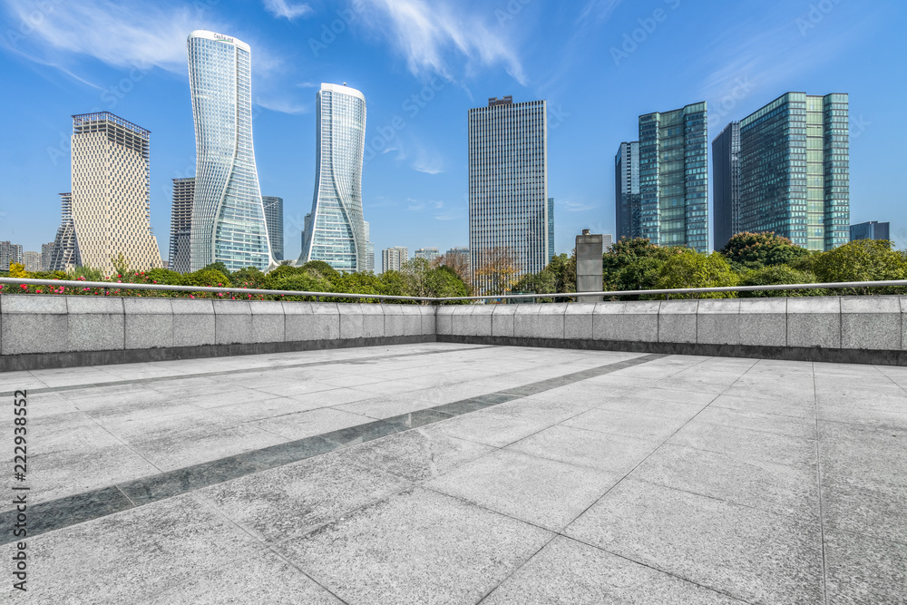 empty pavement and modern buildings in city.