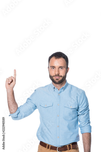 man in blue shirt pointing up isolated on white © LIGHTFIELD STUDIOS