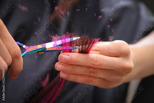 Close-up of a hairdresser cutting the hair of a woman in a beauty salon