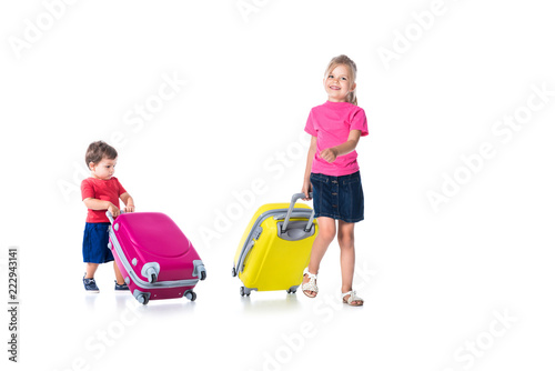 siblings with travel bags isolated on white