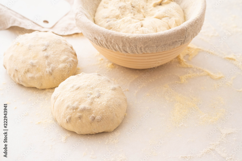 Balls of dough covered with wheat flour ready for baking. Copy space.