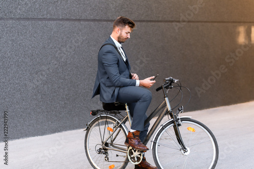 Young businessman going to work with his bicycle.