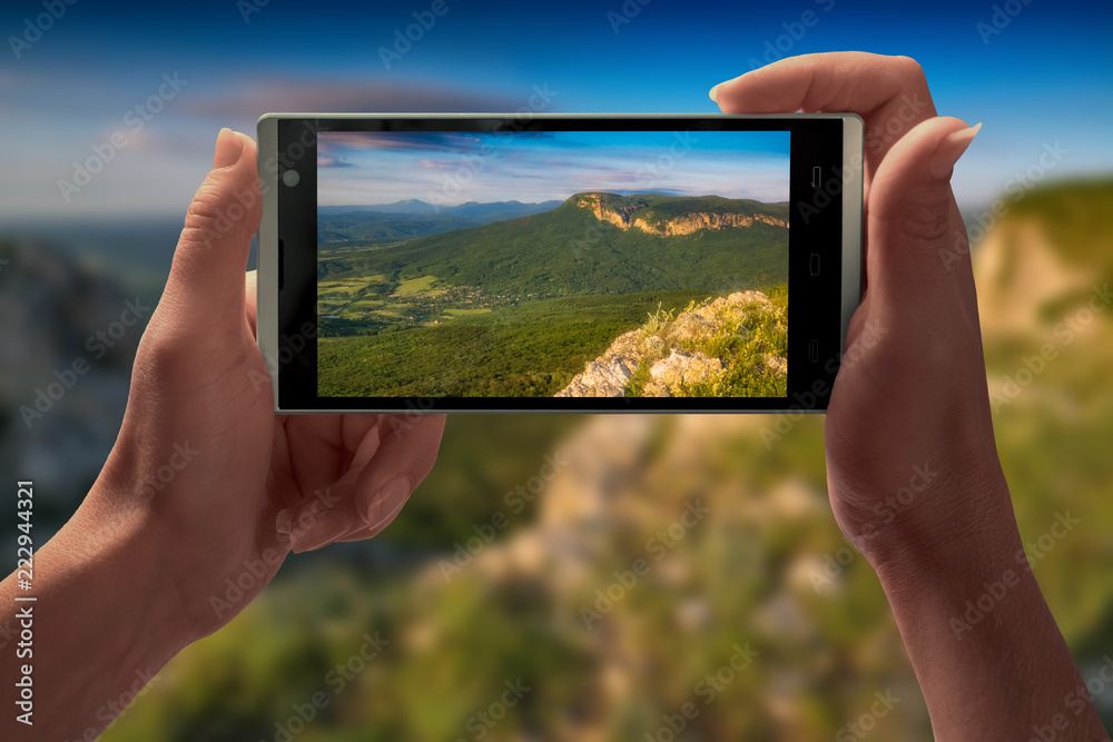 The mountain landscape on a screen of smartphone
