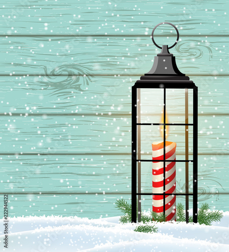 Old lantern with candle on blue wooden background