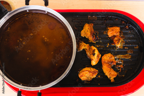 chicken cooked on pan and hot soup