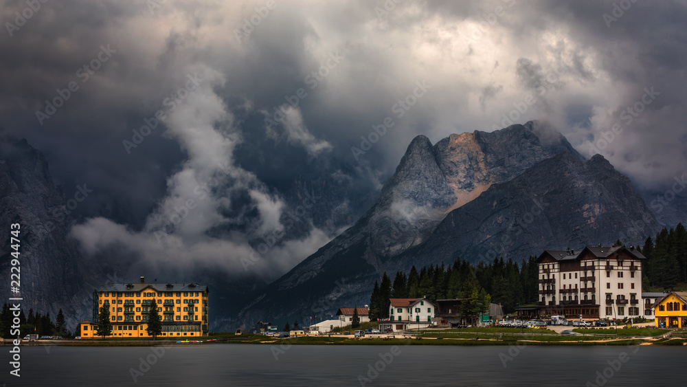 Fototapeta premium Misurina Lake in the Dolomites mountains in Italy near Auronzo di Cadore on a cloudy day, Sorapiss mountain in the background. South Tyrol, Dolomites, Italy.