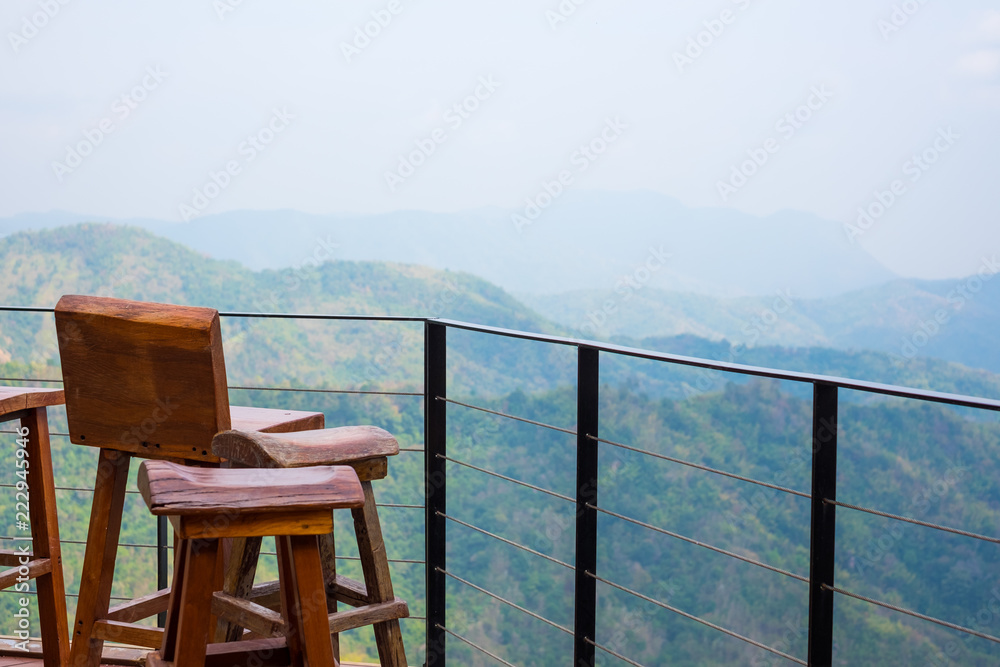 Chair and table of cafe restaurant on balcony deck with mountain forest view. Chair and table of cafe restaurant on balcony deck with mountain forest view.