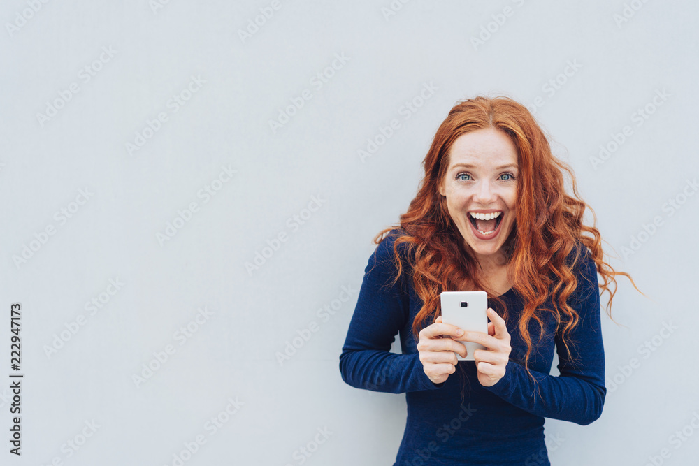 Vivacious young woman laughing at a good joke - obrazy, fototapety, plakaty 