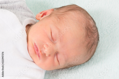 close up portrait baby newborn sleeping in bed