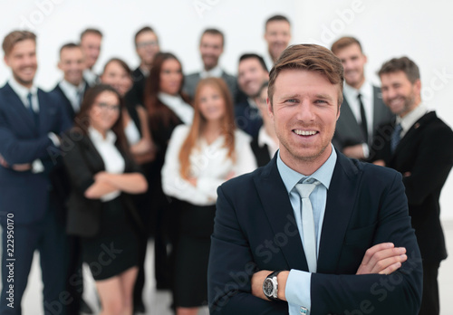 businessman standing in front of a large business team.